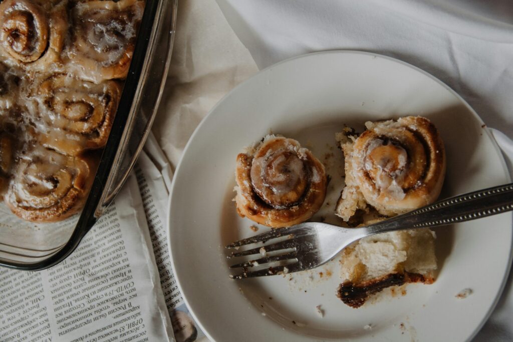pexels-photo-3951307-3951307 Delicious homemade cinnamon rolls served with a fork on a white plate. Perfect for breakfast or dessert indulgence.